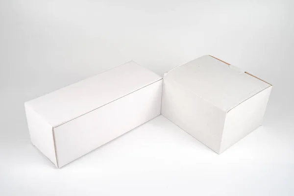 White two paper boxes - tall and fat lay on the white background — Stock Photo, Image