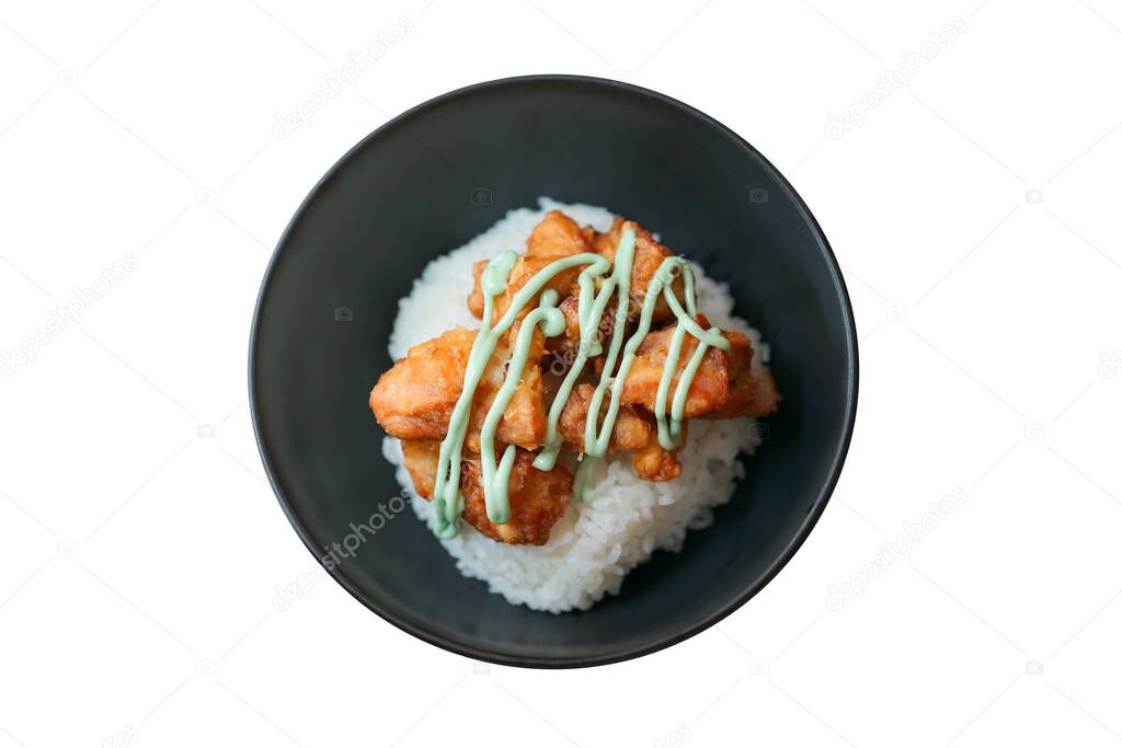 Kara-age wasabi done (fried chicken tipping with wasabi sauce on the rice) in a black bowl is isolated and topview side on white background. Clipping Paths