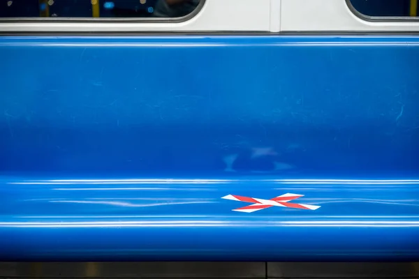 blue seat row in the train with crossed marking tape in Coronavirus (COVID-19) period. It means Social Distancing in transportation.