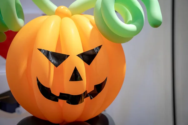 Pumpkin face evil balloon for Halloween party decoration.