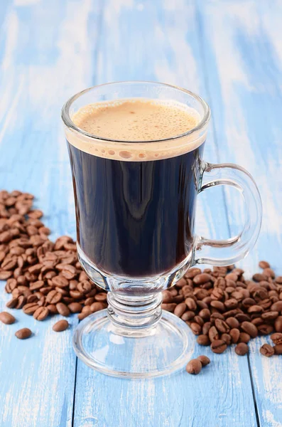 Irish coffee on a blue wooden background with coffee beans