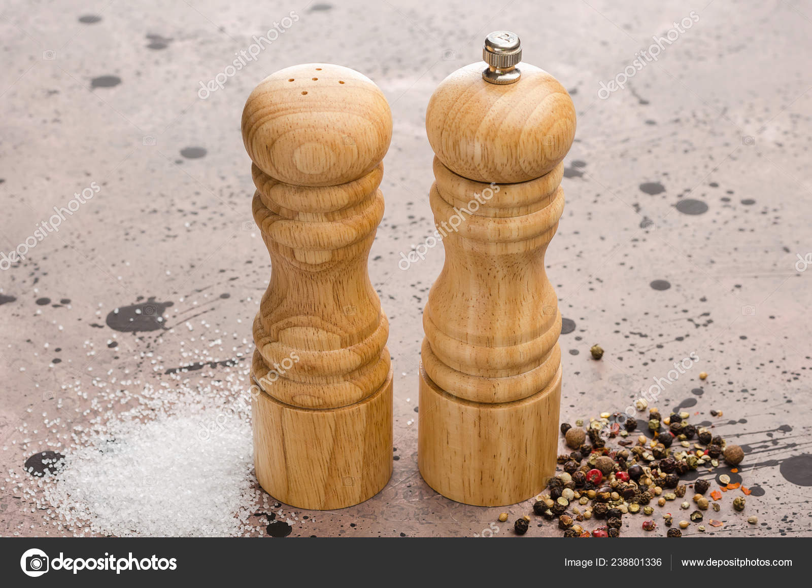 Wooden salt shaker and pepperbox on a light background. Stock Photo by  ©ellymorena 238801336