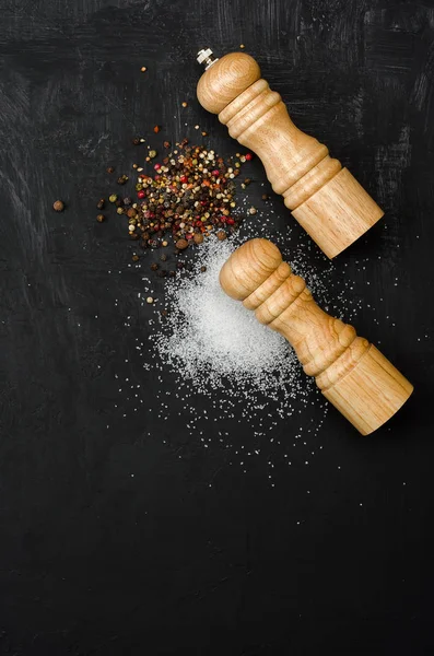 Ahşap tuzluk ve pepperbox siyah tebeşir tahtası üzerinde.