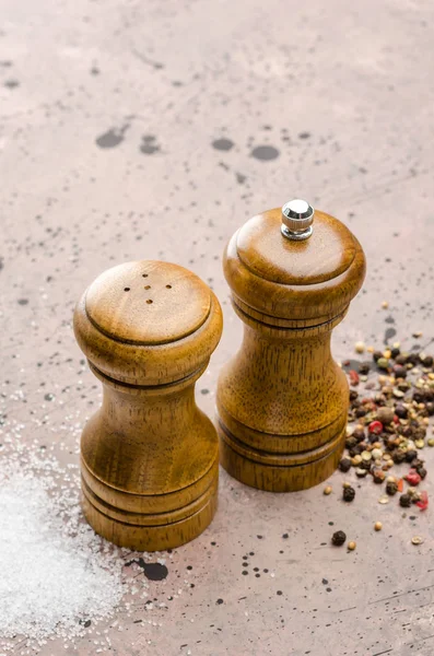 Wooden salt shaker and pepperbox on a light background.