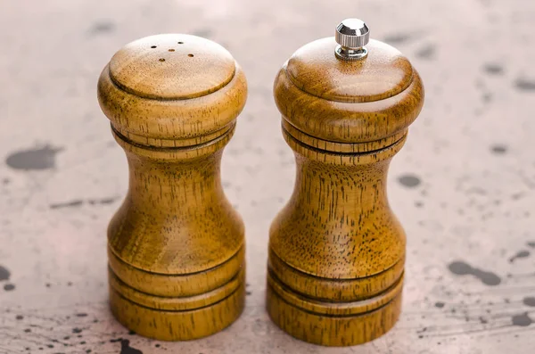 Wooden salt shaker and pepperbox on a light background.