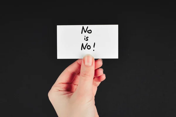 No is no text on a card in woman hand  on a black background.