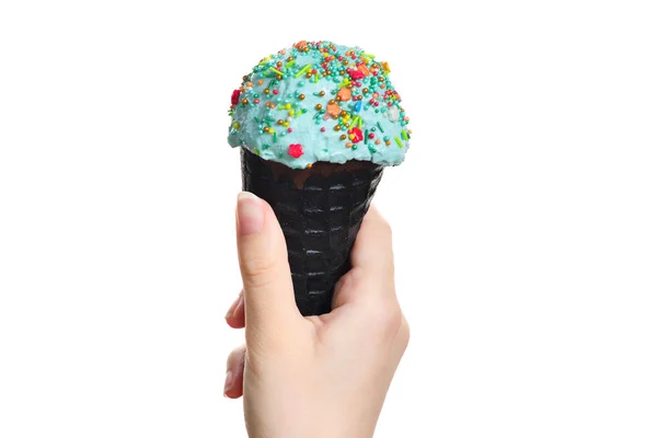 Woman's hand holding black wafer cone with blue ice cream. Isola — Stock Photo, Image
