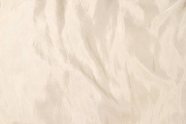 Yumuşak bej ipek kumaş arka plan. Kumaş dokusu. 