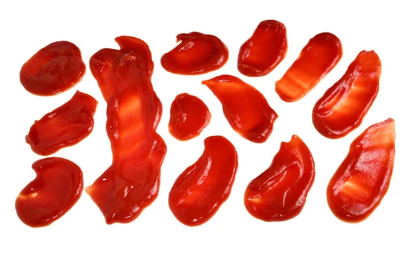 Rote Soße spritzt vereinzelt auf weißem Hintergrund. Ketchup. — Stockfoto