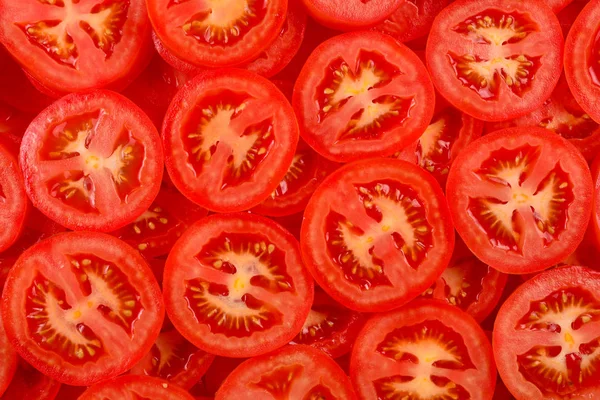 Tomatenhintergrund in Scheiben geschnitten. Ansicht von oben. — Stockfoto