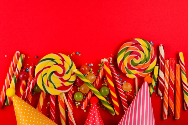 Colorful candies on a red  background. Lollipop. Top view. Copy — Stock Photo, Image