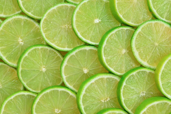 Fresh lime slices as a background. — Stock Photo, Image