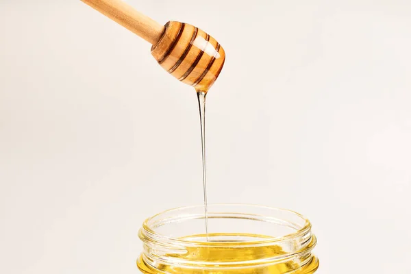 Dipper with honey in woman hand. Space for text or design. — Stock Photo, Image