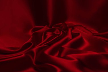Kırmızı ipek ya da saten lüks kumaş dokusu soyut bir arka plan olarak kullanılabilir. Üst görünüm