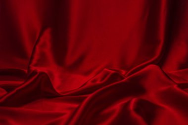 Kırmızı ipek ya da saten lüks kumaş dokusu soyut bir arka plan olarak kullanılabilir. Üst görünüm