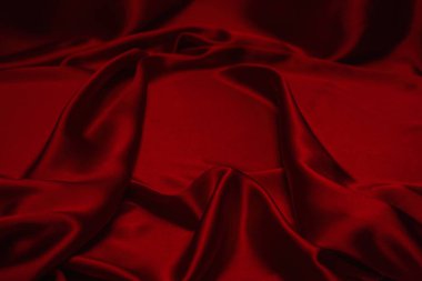 Kırmızı ipek ya da saten lüks kumaş dokusu soyut bir arka plan olarak kullanılabilir. Üst görünüm