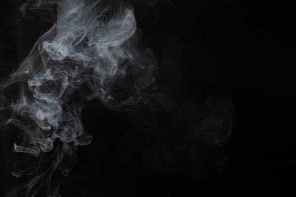 White steam on a black background. Copy space.