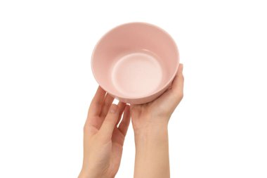 Beyaz arka planda izole edilmiş pembe tabak kadının ellerinde..