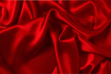Kırmızı ipek ya da saten lüks kumaş dokusu soyut bir arka plan olarak kullanılabilir. Üst görünüm.