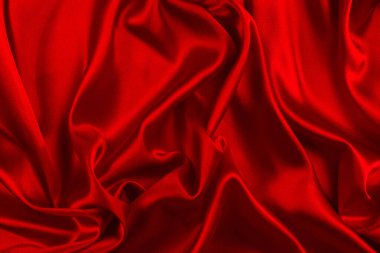 Kırmızı ipek ya da saten lüks kumaş dokusu soyut bir arka plan olarak kullanılabilir. Üst görünüm.