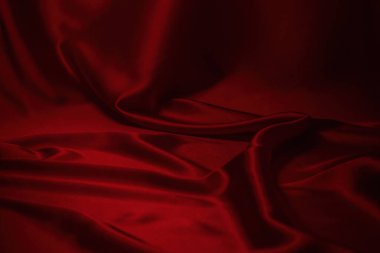 Kırmızı ipek ya da saten lüks kumaş dokusu soyut bir arka plan olarak kullanılabilir. Üst görünüm
