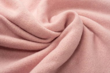 Yumuşak pembe kaşmir süveter desenli arka plan. Üst görünüm. 