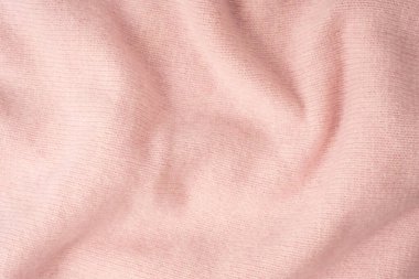 Yumuşak pembe kaşmir süveter desenli arka plan. Üst görünüm. 