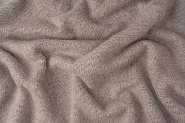 Arka plan olarak yumuşak gri merino yün süveter dokusu. Üst görünüm.