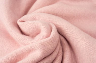 Yumuşak pembe kaşmir süveter desenli arka plan. Üst görünüm. 