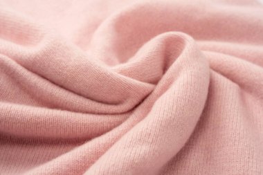 Yumuşak pembe kaşmir süveter desenli arka plan. Üst görünüm. 