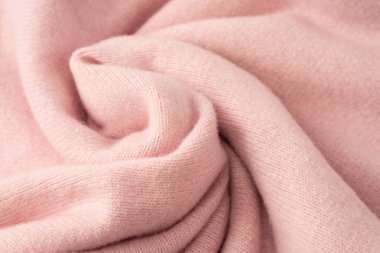 Yumuşak pembe kaşmir süveter desenli arka plan. Üst görünüm. 