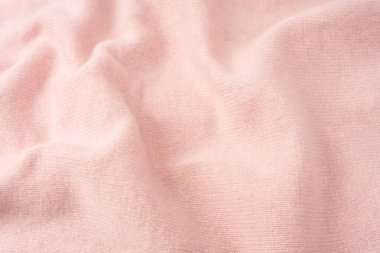 Yumuşak pembe kaşmir süveter desenli arka plan. Üst görünüm. 