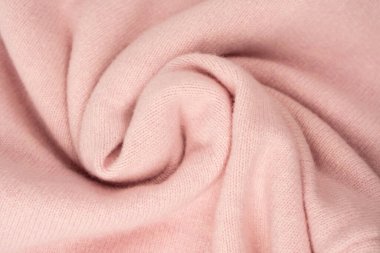 Yumuşak pembe kaşmir süveter desenli arka plan. Üst görünüm. 