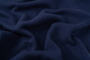 Arka plan olarak lacivert merino yün süveter dokusu. Üst görünüm. 