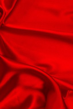 Kırmızı ipek ya da saten lüks kumaş dokusu soyut bir arka plan olarak kullanılabilir. Üst görünüm.