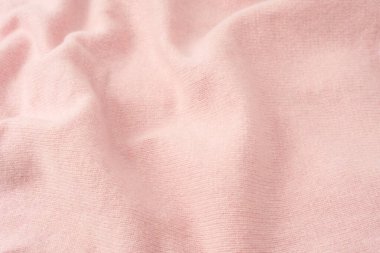 Yumuşak pembe kaşmir süveter desenli arka plan. Üst görünüm. 