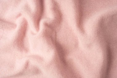 Yumuşak pembe kaşmir süveter desenli arka plan. Üst görünüm. 