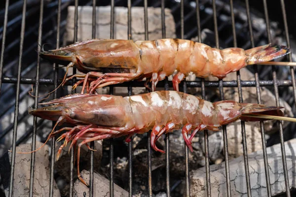 Grilled shrimp or easy BBQ grilled shrimp on grill. Grilled shrimps on the flaming grill. Diet or cooking concept.