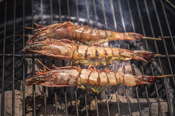 Grilled shrimp or easy BBQ grilled shrimp on grill. Grilled shrimps on the flaming grill. Diet or cooking concept.