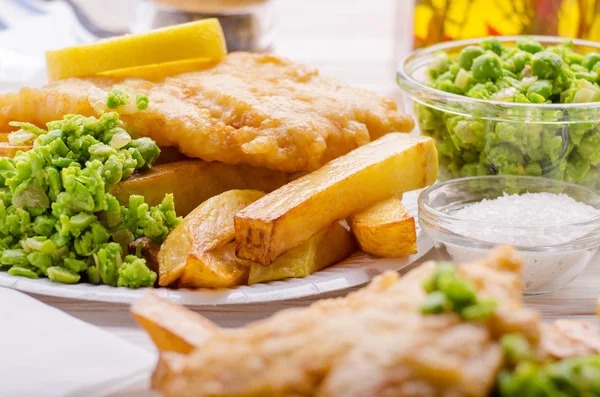 Traditional British street food fish and chips with mushy peas o
