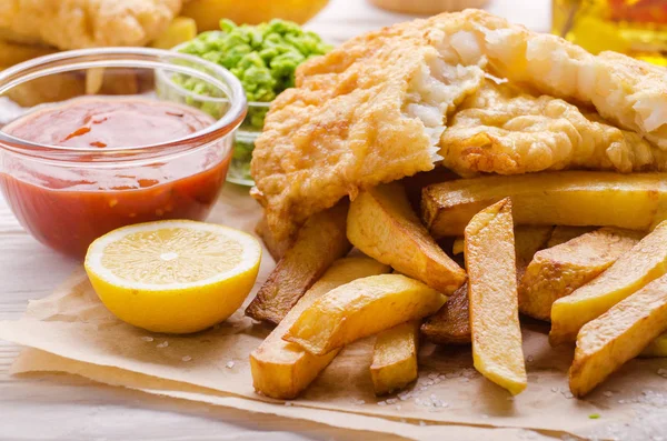 Traditional British street food fish and chips with mushy peas a