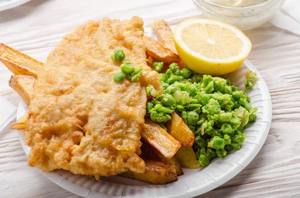 Traditional British street food fish and chips with tartar sauce