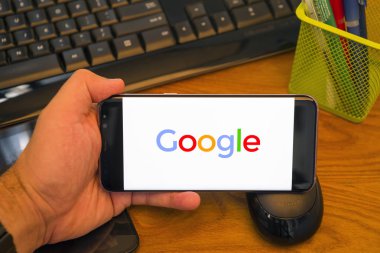 Piatra Neamt, Romanya - 30 Temmuz 2018: El Samsung S8 + Google ile tutan üstünde belgili tanımlık perde, office arka plan.