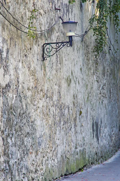 Street lamp on aged wall