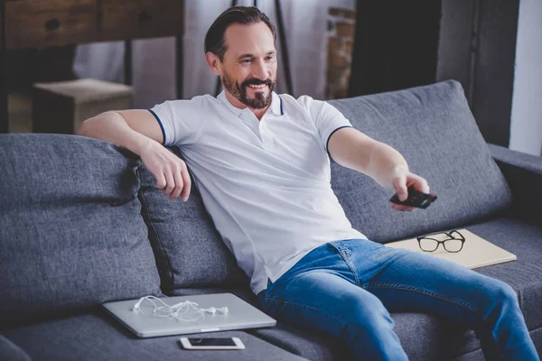 adam evde tv izlerken kanepede gülümseyen portresi sakallı
