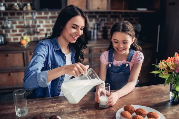 Retrato Madre Sonriente Vertiendo Leche Vaso Para Hija Cocina — Foto de Stock