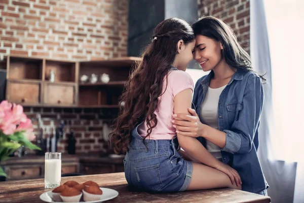 Ritratto Della Madre Che Abbraccia Figlia Seduta Sul Tavolo Cucina — Foto Stock