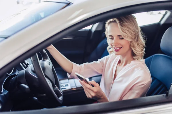 Kuva Houkutteleva Valkoihoinen Nainen Istuu Autossa Käyttää Älypuhelinta — kuvapankkivalokuva