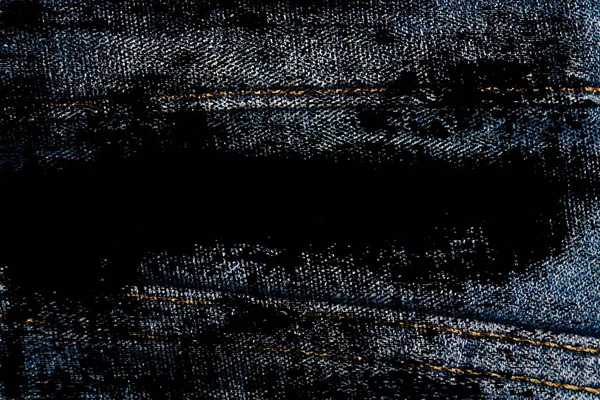 Grunge dirty Closeup of obsolete blue jeans laces Denim texture, macro background for web site or mobile devices