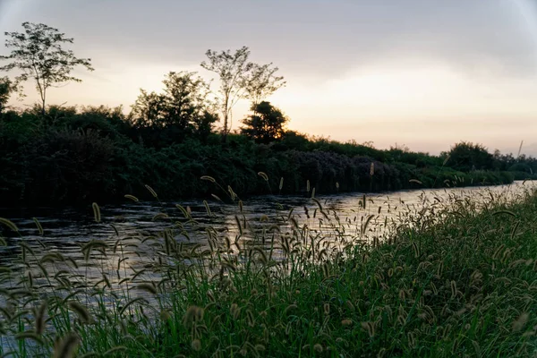 Vista del río, puesta de sol sobre las montañas, superficie del agua con reflejo . — Foto de Stock